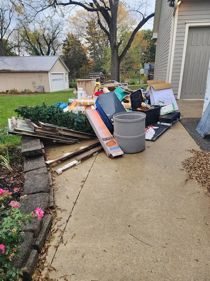 Dumpster being loaded with debris for 12 Yard Dumpster Rental in Barnstead